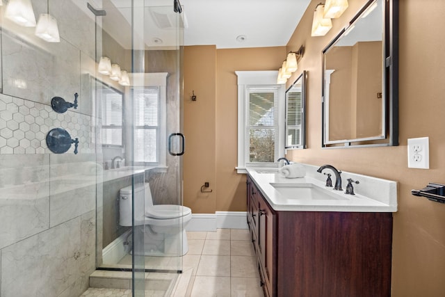 bathroom featuring a sink, toilet, and a shower stall