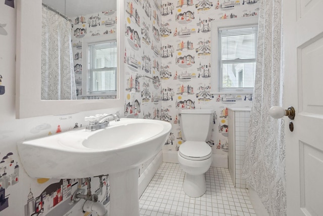 bathroom with tile patterned floors, toilet, and wallpapered walls
