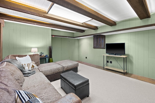 carpeted living room featuring beamed ceiling