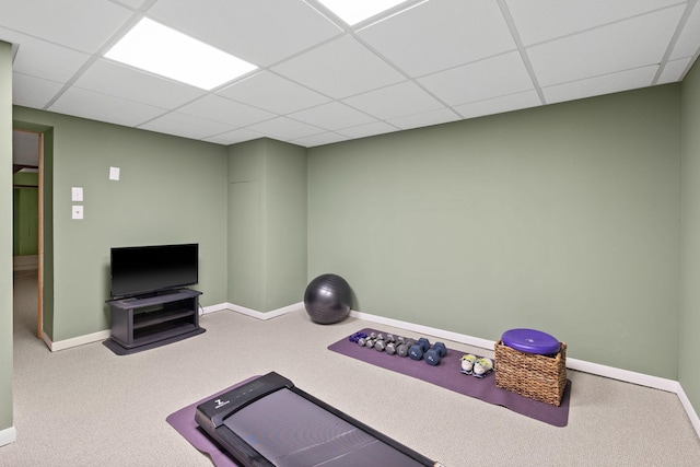 workout area with carpet floors, baseboards, and a drop ceiling