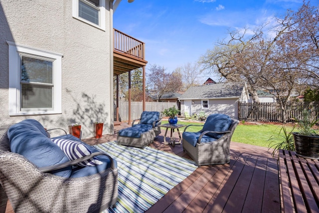wooden deck featuring a fenced backyard, a yard, and an outdoor hangout area