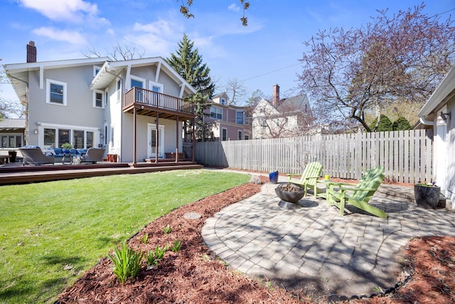 exterior space featuring fence, an outdoor living space with a fire pit, a deck, a balcony, and a patio