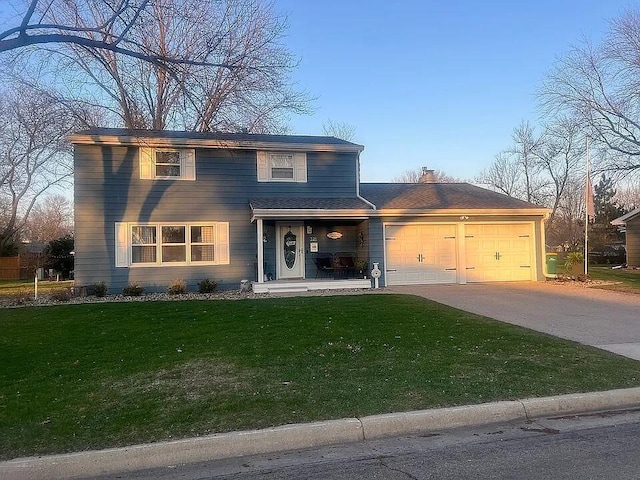 traditional home featuring a garage, a front lawn, a chimney, and concrete driveway