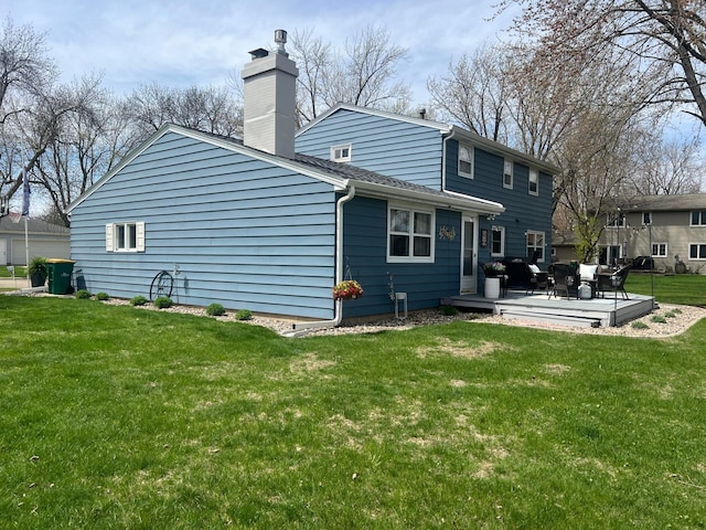rear view of property featuring a wooden deck, a chimney, an outdoor living space, a shingled roof, and a lawn