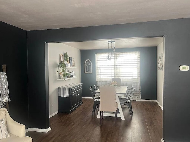 dining space with baseboards and dark wood-style flooring