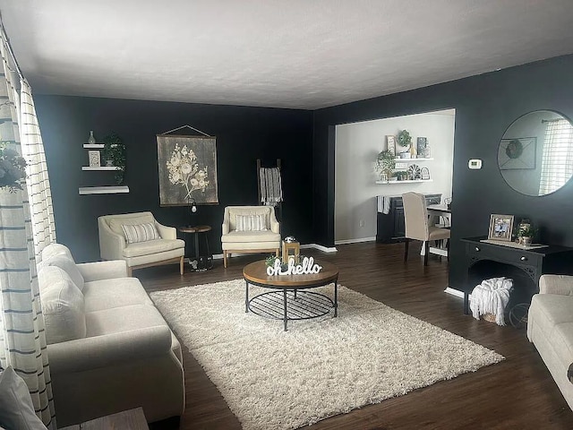 living room with baseboards and wood finished floors