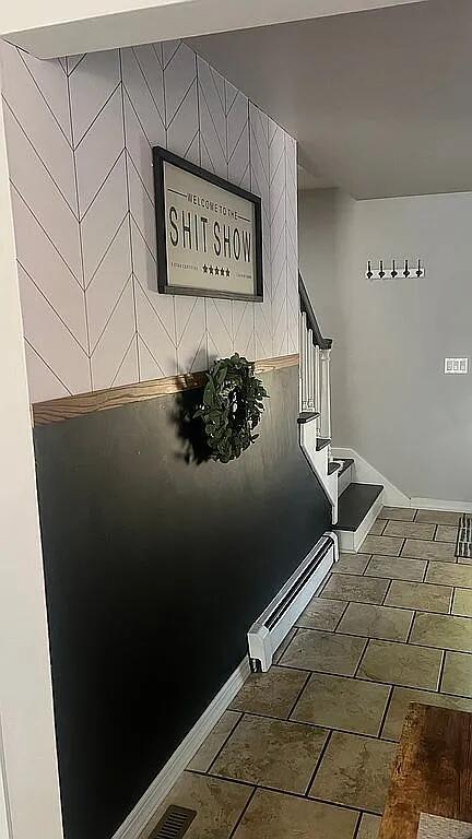staircase featuring baseboards