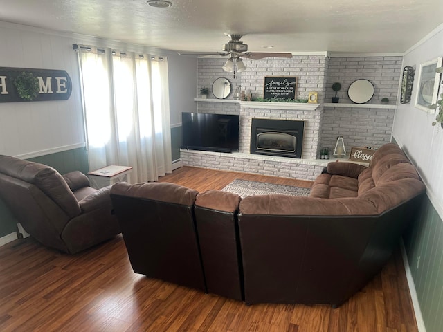 321 Meredith Rd, Albert Lea, MN 56007 - living room featuring ceiling fan, wood finished floors, crown molding, a fireplace, and baseboards