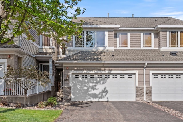 15601 Lilac Dr, Eden Prairie, MN 55347 - multi unit property with driveway, a shingled roof, an attached garage, and stone siding