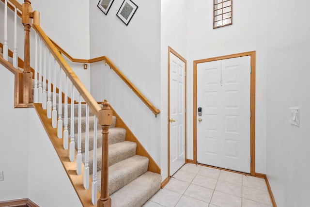 15601 Lilac Dr, Eden Prairie, MN 55347 - foyer with a towering ceiling, light tile patterned floors, baseboards, and stairs