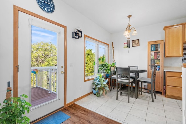 15601 Lilac Dr, Eden Prairie, MN 55347 - dining room featuring baseboards, a chandelier, and light wood finished floors