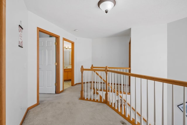 15601 Lilac Dr, Eden Prairie, MN 55347 - hallway featuring an upstairs landing, light carpet, and baseboards