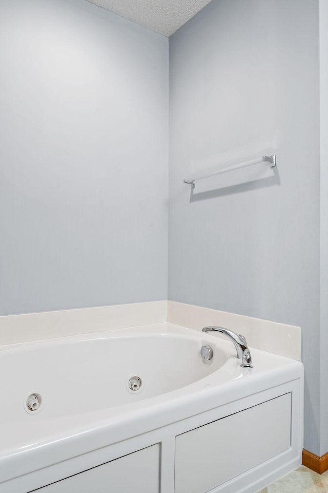 15601 Lilac Dr, Eden Prairie, MN 55347 - full bathroom featuring a jetted tub and a textured ceiling