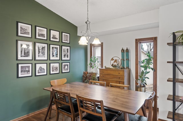 dining space with wood finished floors and baseboards