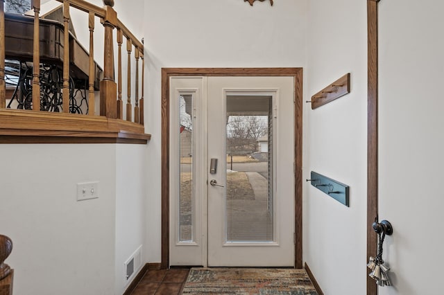doorway to outside featuring visible vents and baseboards