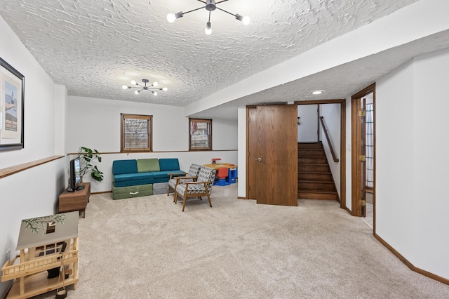 living area with baseboards, stairway, a notable chandelier, and carpet