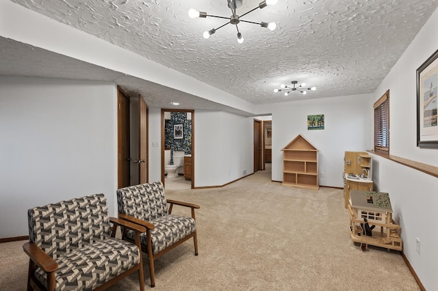 living area with light colored carpet, a notable chandelier, and baseboards