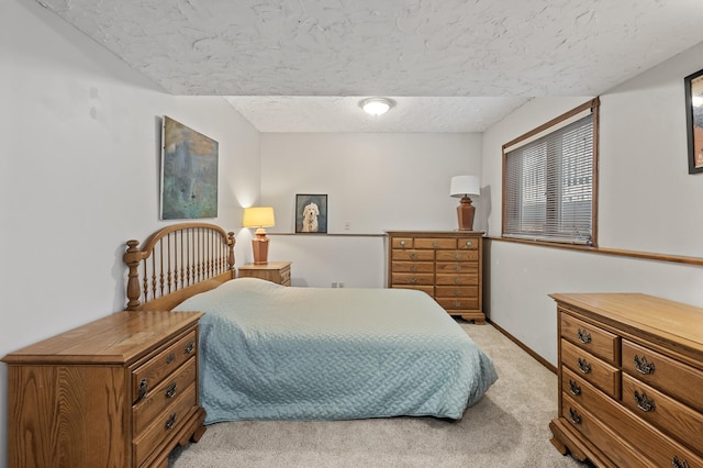 bedroom featuring baseboards and light carpet