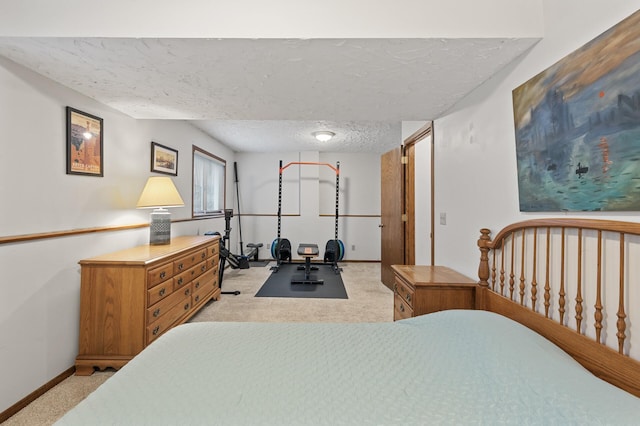 bedroom with a textured ceiling, baseboards, and light carpet
