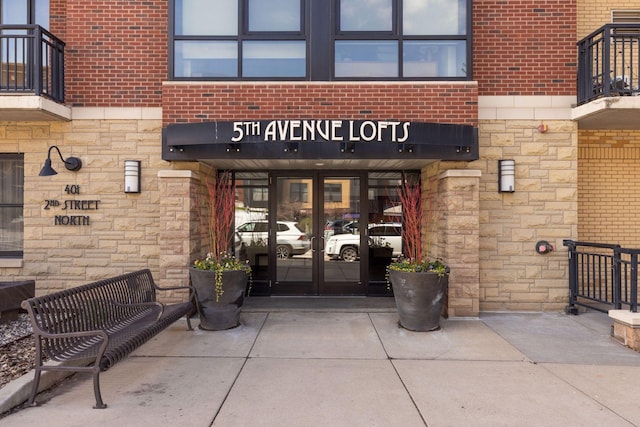 401 2nd St Unit 202, Minneapolis, MN 55401 - view of exterior entry featuring french doors, brick siding, and stone siding