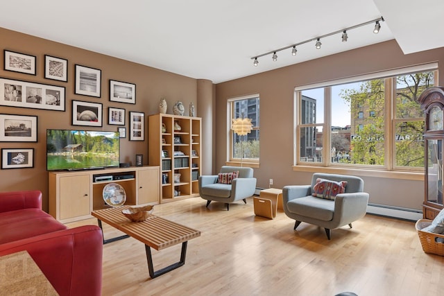 401 2nd St Unit 202, Minneapolis, MN 55401 - living area with wood finished floors, a baseboard heating unit, and rail lighting