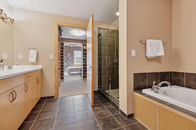 401 2nd St Unit 202, Minneapolis, MN 55401 - bathroom with a shower stall, vanity, tile patterned floors, a ceiling fan, and a garden tub