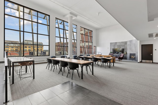 401 2nd St Unit 202, Minneapolis, MN 55401 - carpeted dining area with tile patterned floors, visible vents, a glass covered fireplace, and plenty of natural light