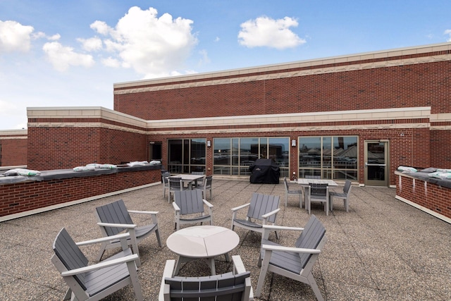 401 2nd St Unit 202, Minneapolis, MN 55401 - rear view of house featuring outdoor dining space, a fire pit, and a patio area