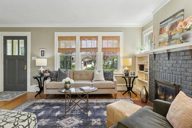 living area with plenty of natural light, ornamental molding, a brick fireplace, wood finished floors, and baseboards