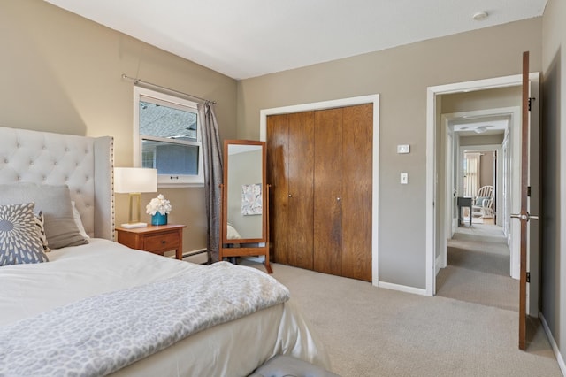 bedroom featuring carpet, multiple windows, a closet, and baseboards