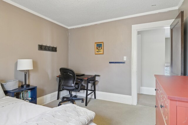 bedroom featuring crown molding, a textured ceiling, carpet floors, baseboards, and a desk