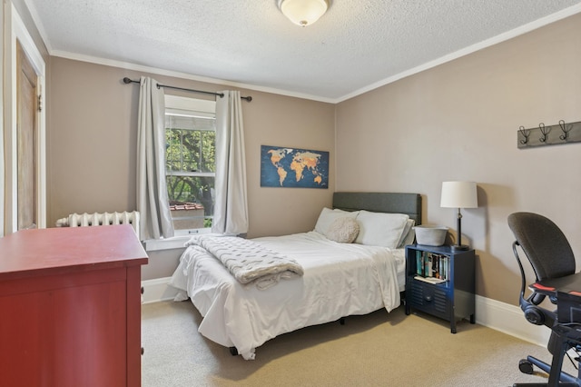 bedroom featuring a textured ceiling, ornamental molding, carpet, radiator heating unit, and a desk