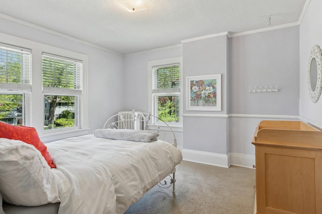bedroom featuring ornamental molding, carpet flooring, multiple windows, a textured ceiling, and baseboards