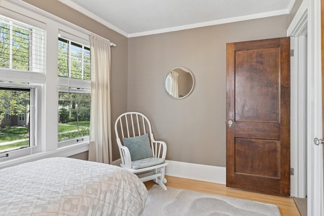 bedroom featuring crown molding and wood finished floors