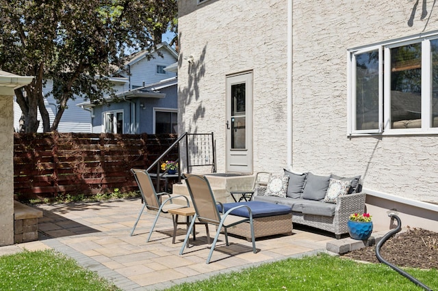 view of patio / terrace with an outdoor living space and fence