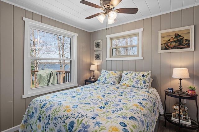 bedroom featuring crown molding, a ceiling fan, and multiple windows