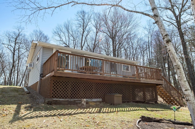 back of property with stairs, a yard, and a deck