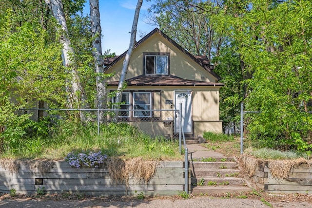 view of front of property featuring fence and stucco siding