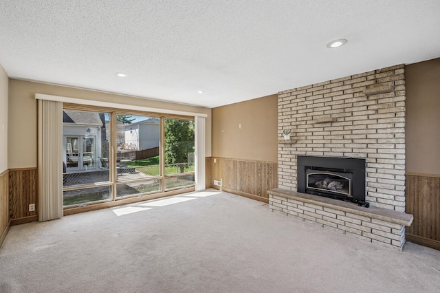 unfurnished living room featuring a wainscoted wall and wood walls