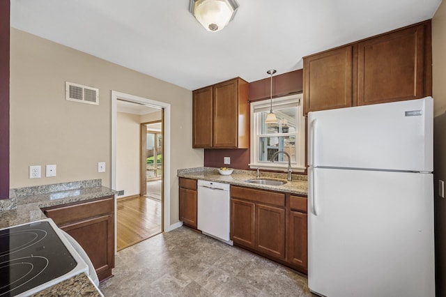 kitchen with plenty of natural light, a sink, visible vents, and white appliances