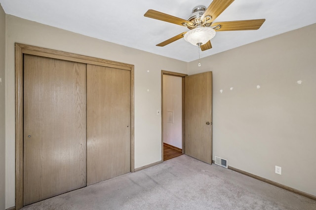 unfurnished bedroom featuring visible vents, a closet, baseboards, a ceiling fan, and carpet