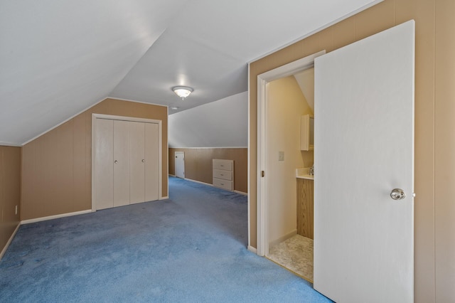 bonus room with carpet floors and vaulted ceiling