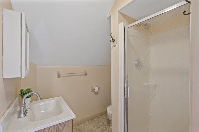 bathroom with vanity, baseboards, a shower stall, and toilet