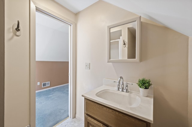 bathroom featuring baseboards, visible vents, and vanity