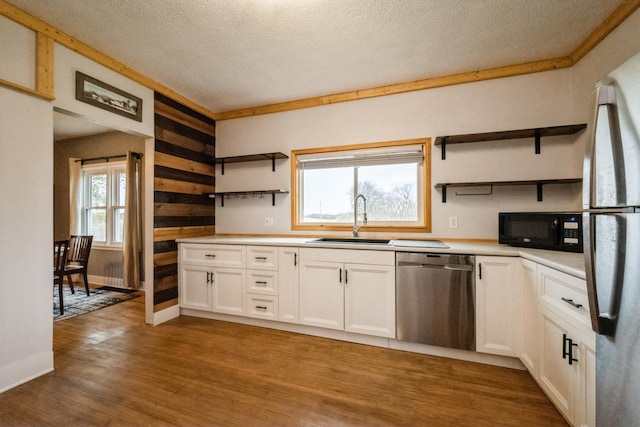 17492 460th Ln, Waterville, MN 56096 - kitchen featuring a sink, wood finished floors, open shelves, white cabinets, and appliances with stainless steel finishes