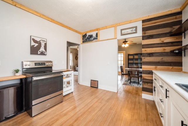 17492 460th Ln, Waterville, MN 56096 - kitchen featuring a ceiling fan, stainless steel electric range, white cabinets, light countertops, and light wood-style floors