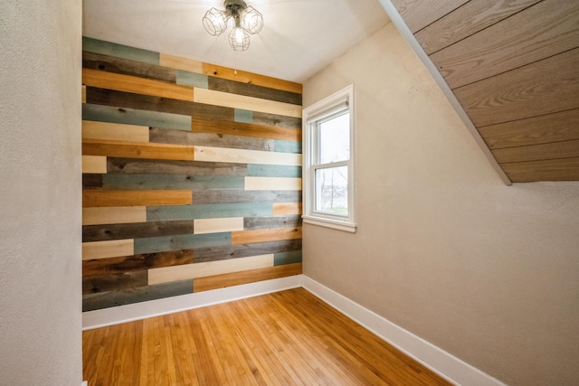 17492 460th Ln, Waterville, MN 56096 - unfurnished room with wood finished floors, wooden walls, and baseboards