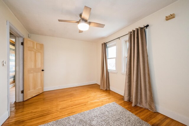 17492 460th Ln, Waterville, MN 56096 - unfurnished room with light wood-style flooring, baseboards, and a ceiling fan