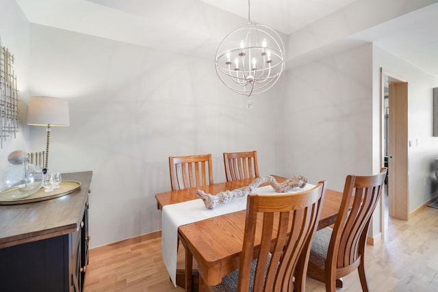 dining area with an inviting chandelier and light wood-type flooring