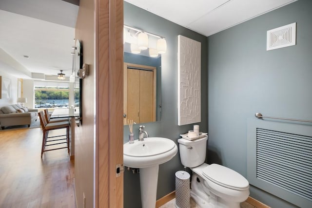 bathroom featuring toilet, visible vents, and wood finished floors